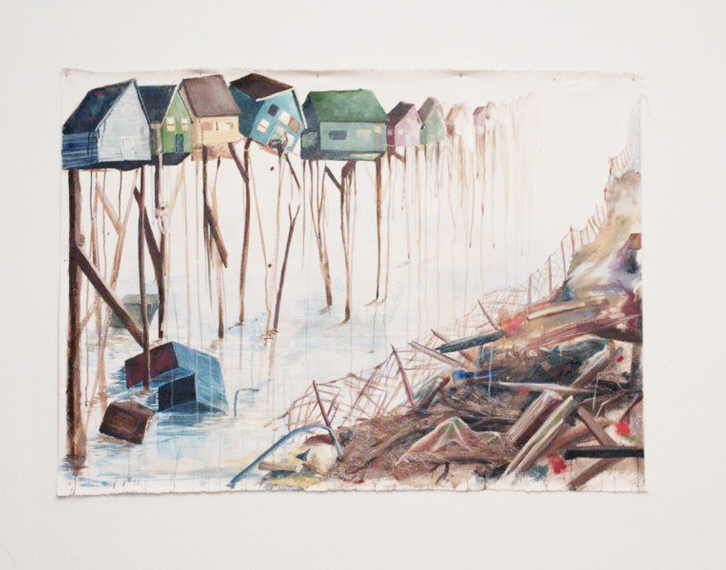 Painting student work featuring a row of colorful houses on stilts and opposite a pile of rubbish.