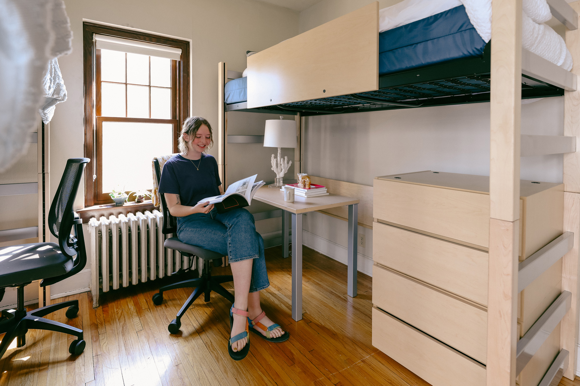Student working at their loft bed desk in a 2550 apartment
