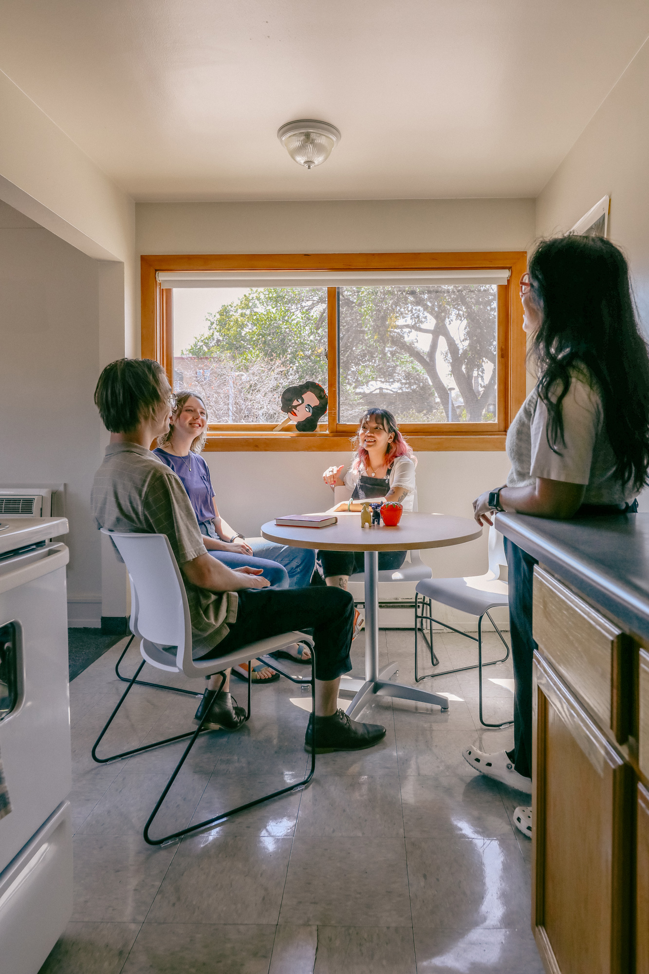 Students sitting at a dining table together in the triplets