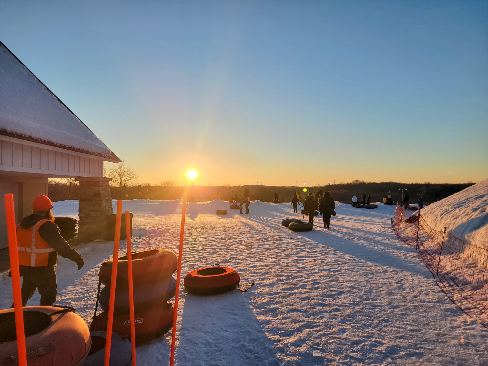 Close up of a sledding shed on a snowy hill with red sleds in-front of it