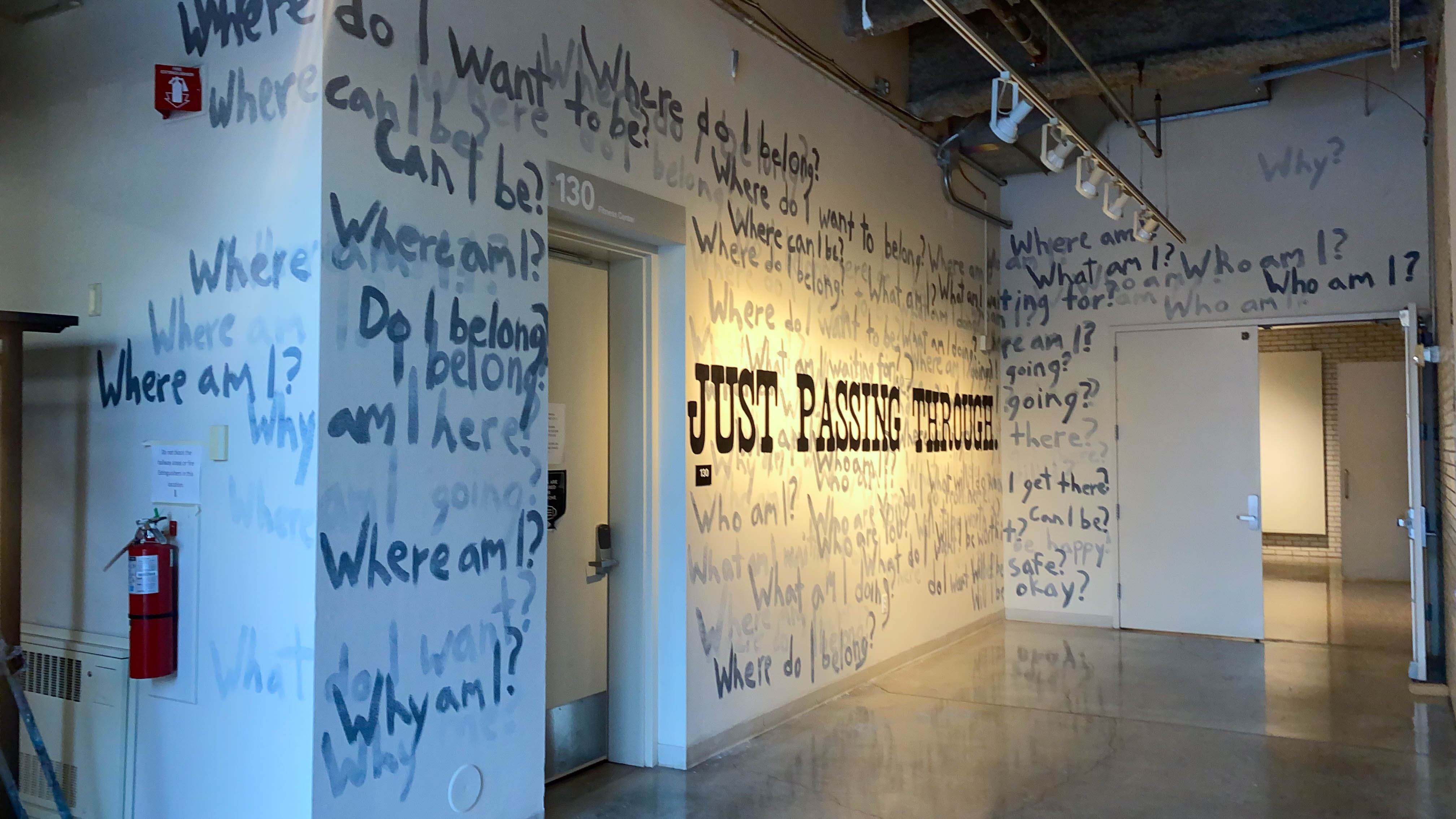 An installation with a bunch of words painted on the wall
