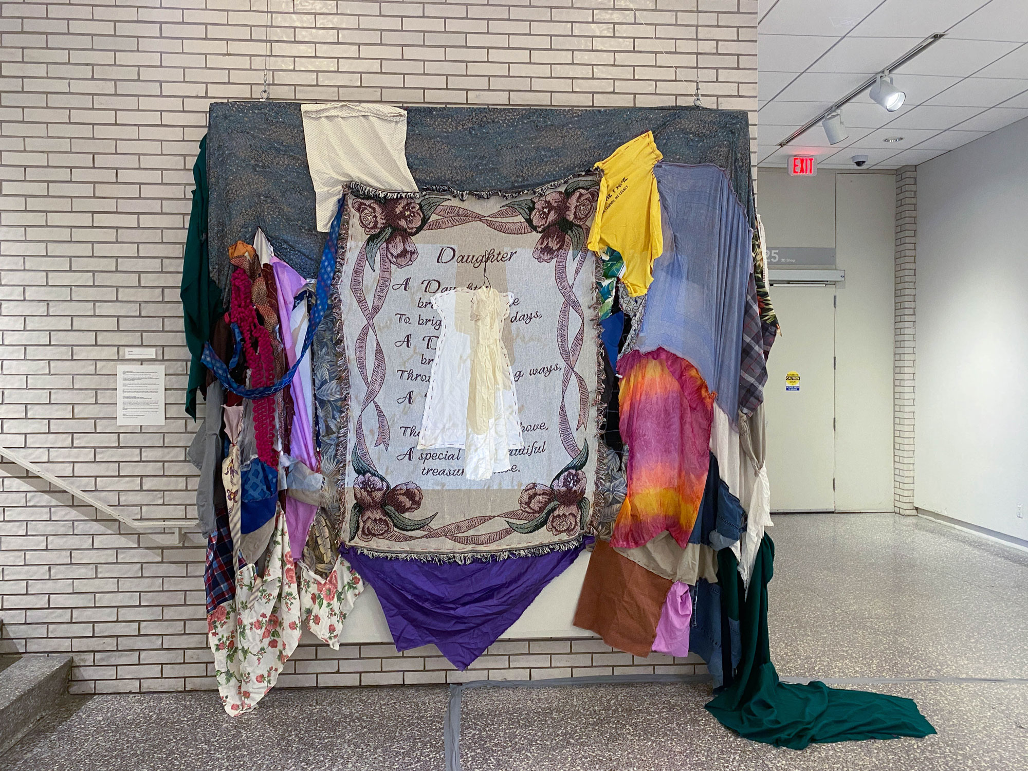 An installation featuring pieces of fabric and blankets