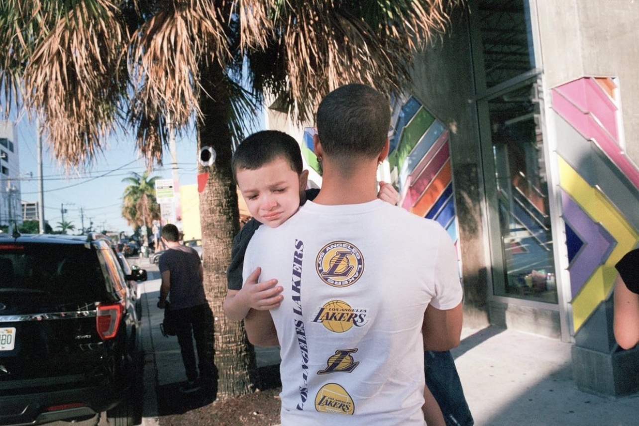 Photograph of a man holding a child