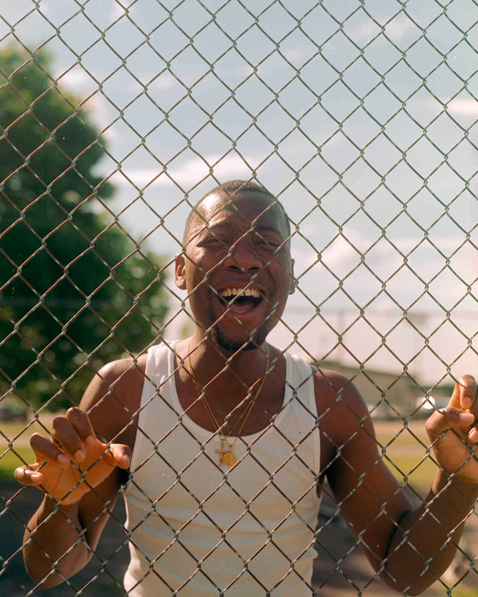 Photo of a person behind a chain link fence