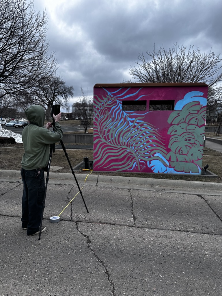 Olaf Kuhlke. MCAD Student Connor Johnson on campus testing a 3-D camera for future fieldwork. 