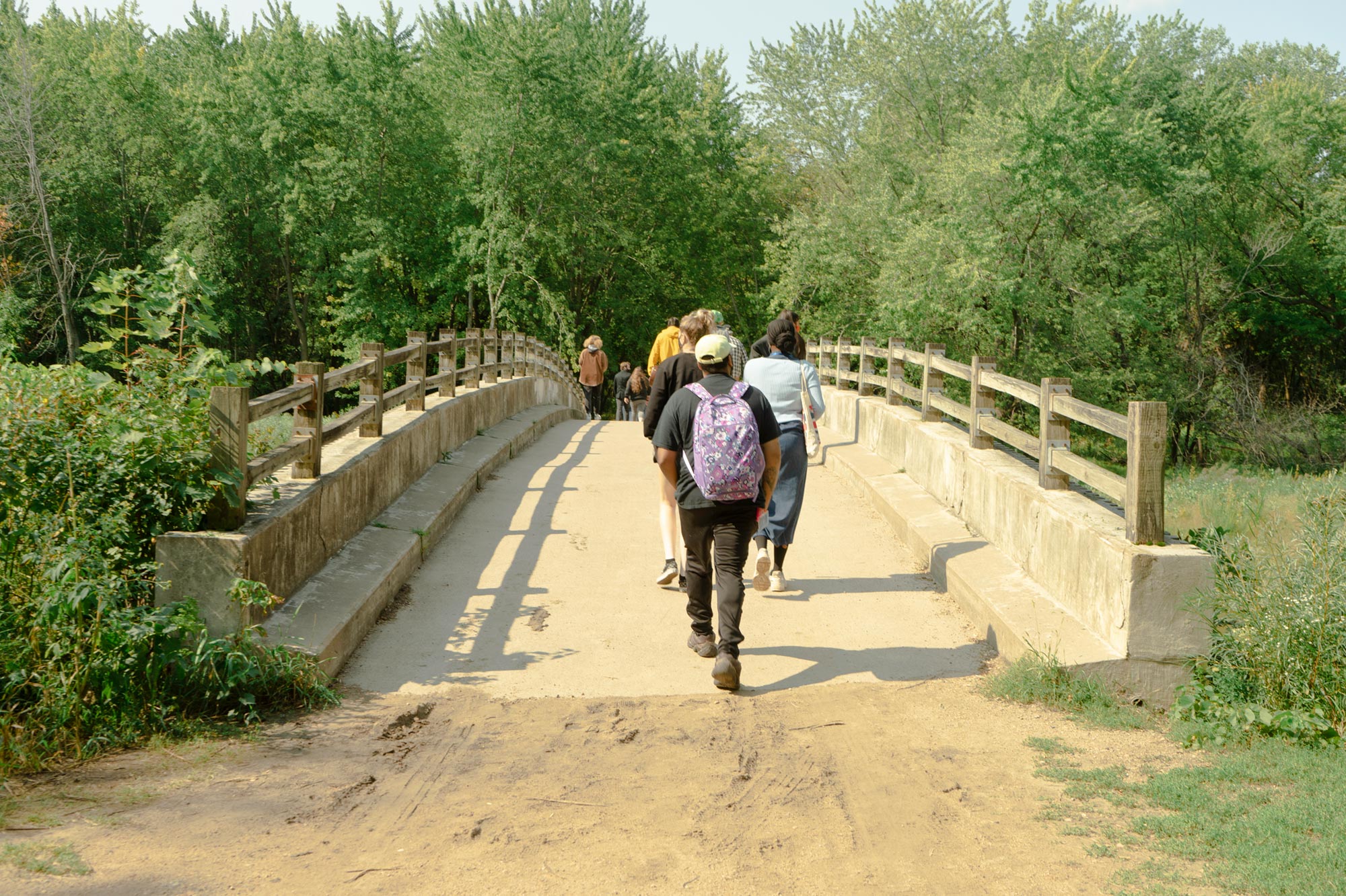 Students walking over a bridge