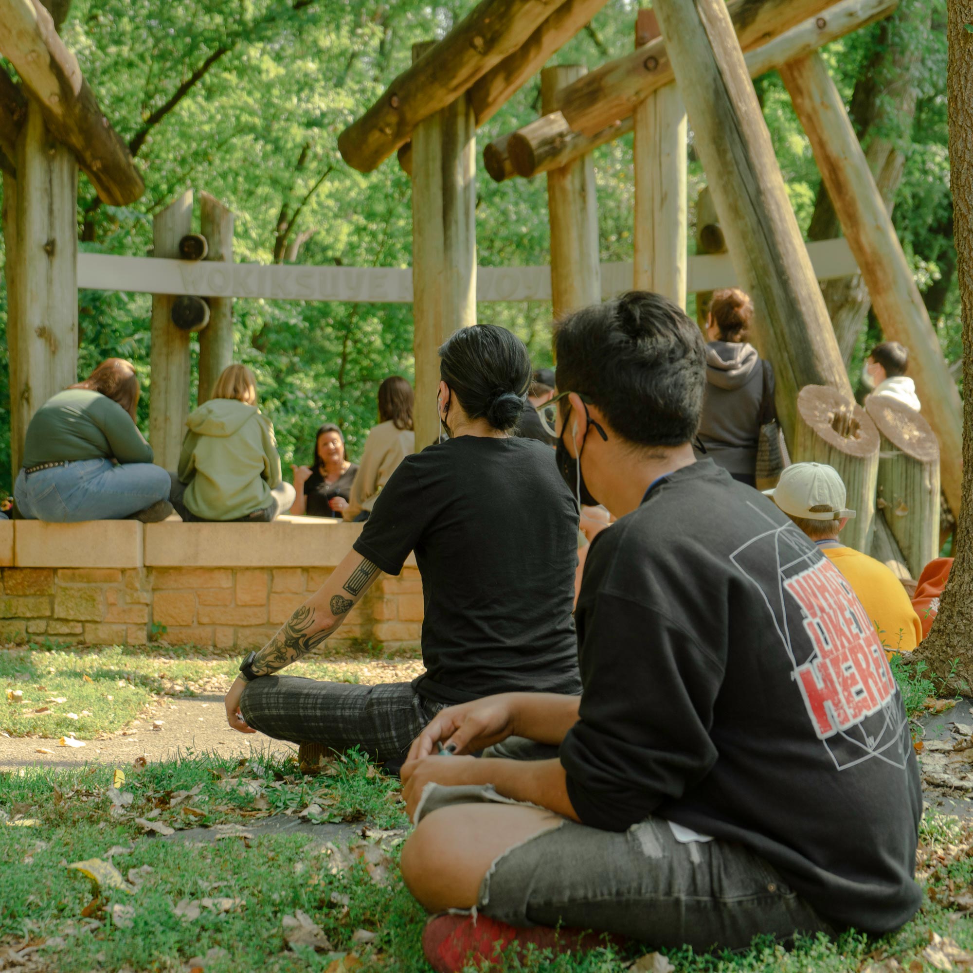 Students listening to a speaker at Bdote