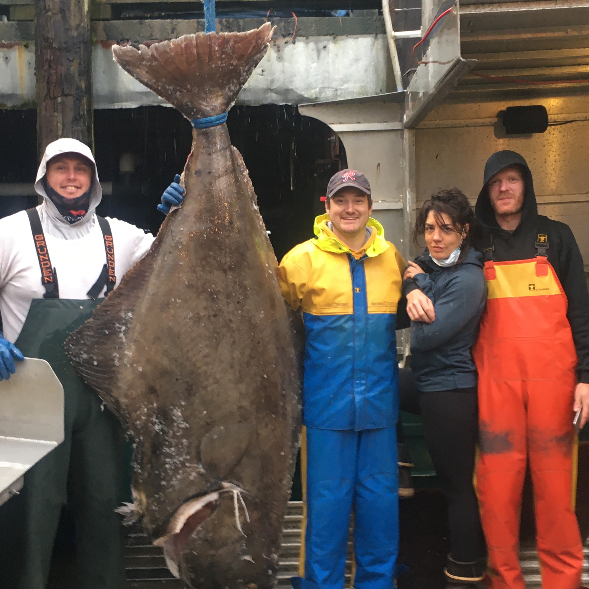 Kat Miller and team members posing with large fish