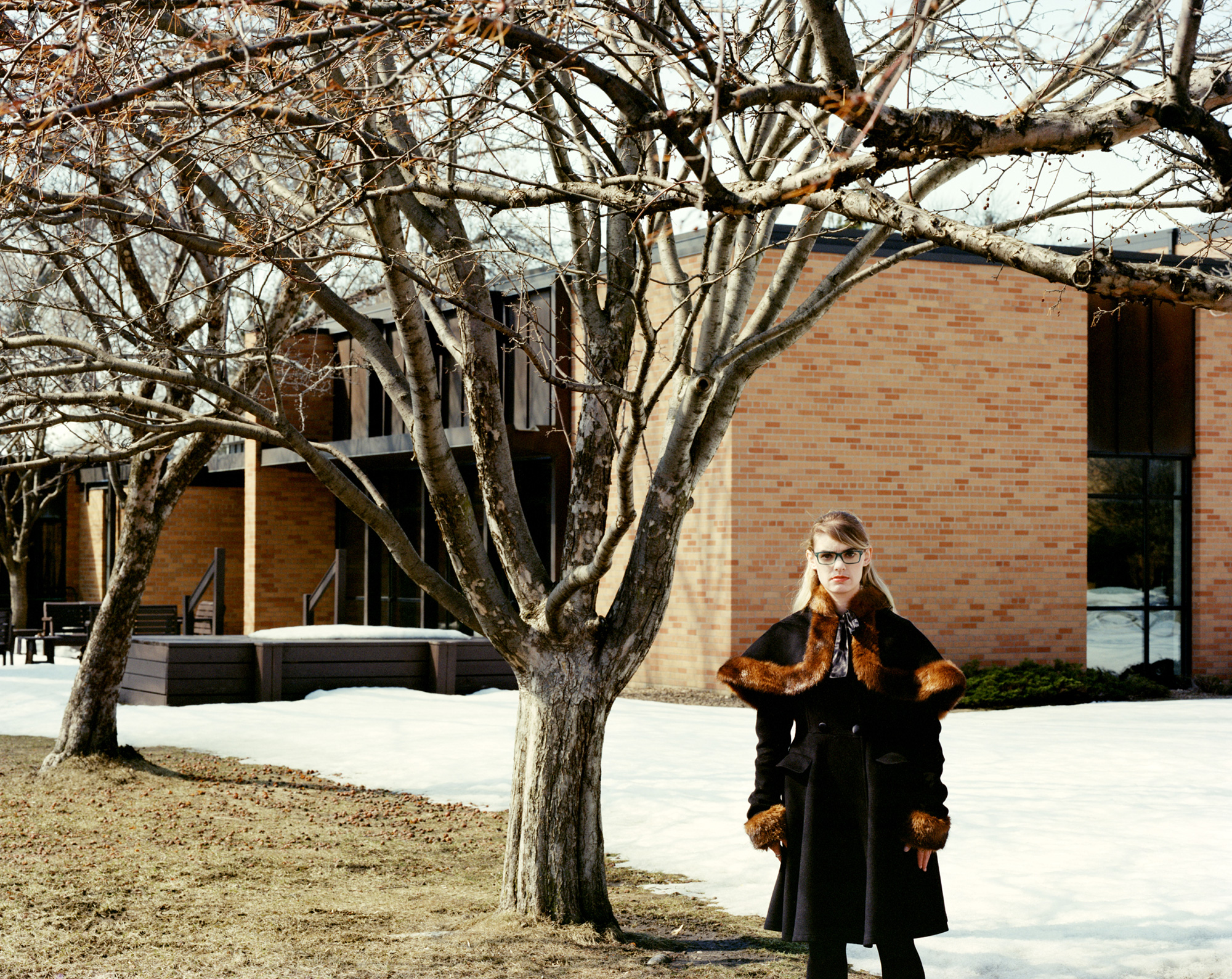 Photo of a person standing in front of a building