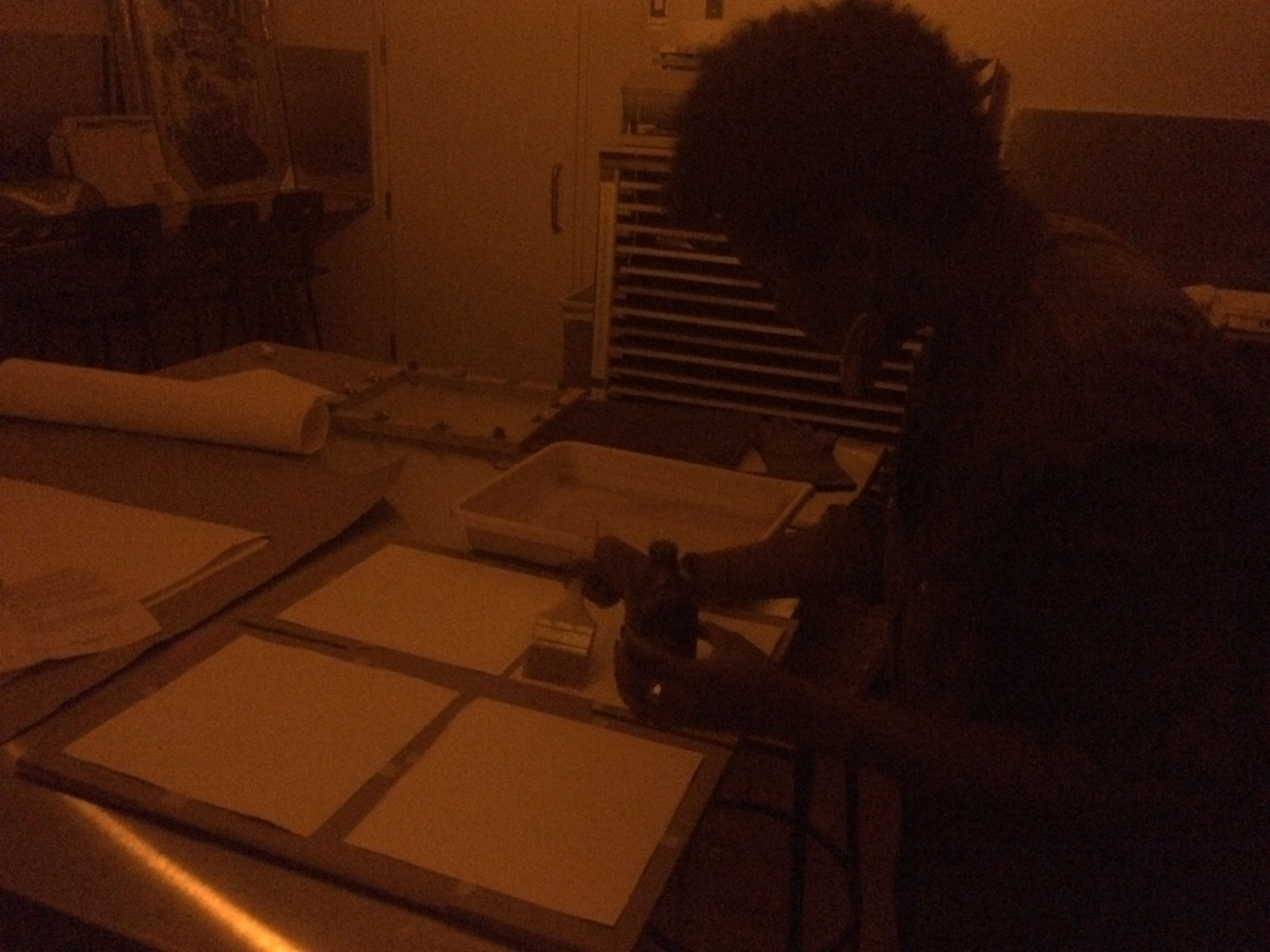 Jovan Speller working in darkroom at MCAD, 2017, digital photograph. 