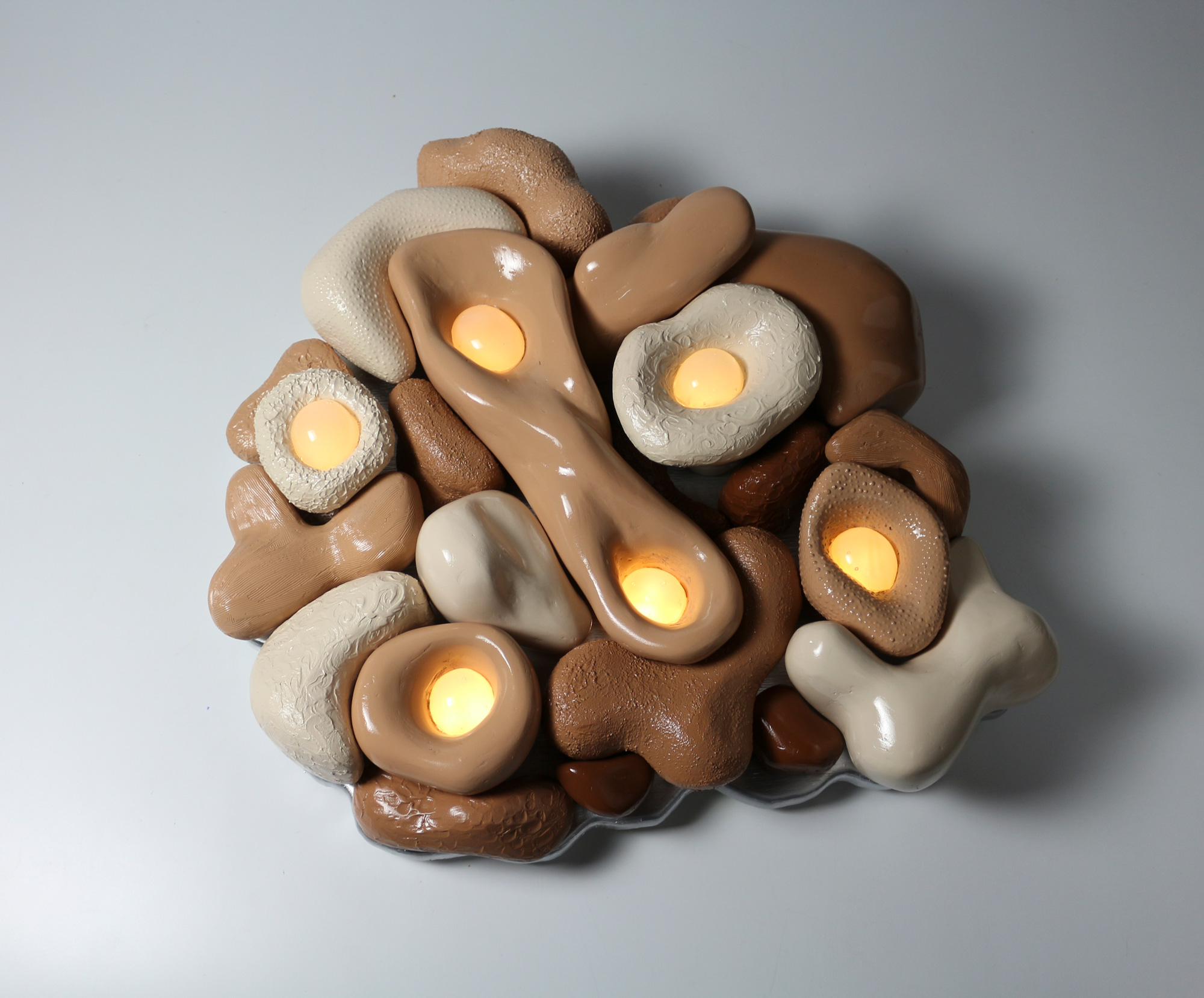 Sculpture featuring clay and light