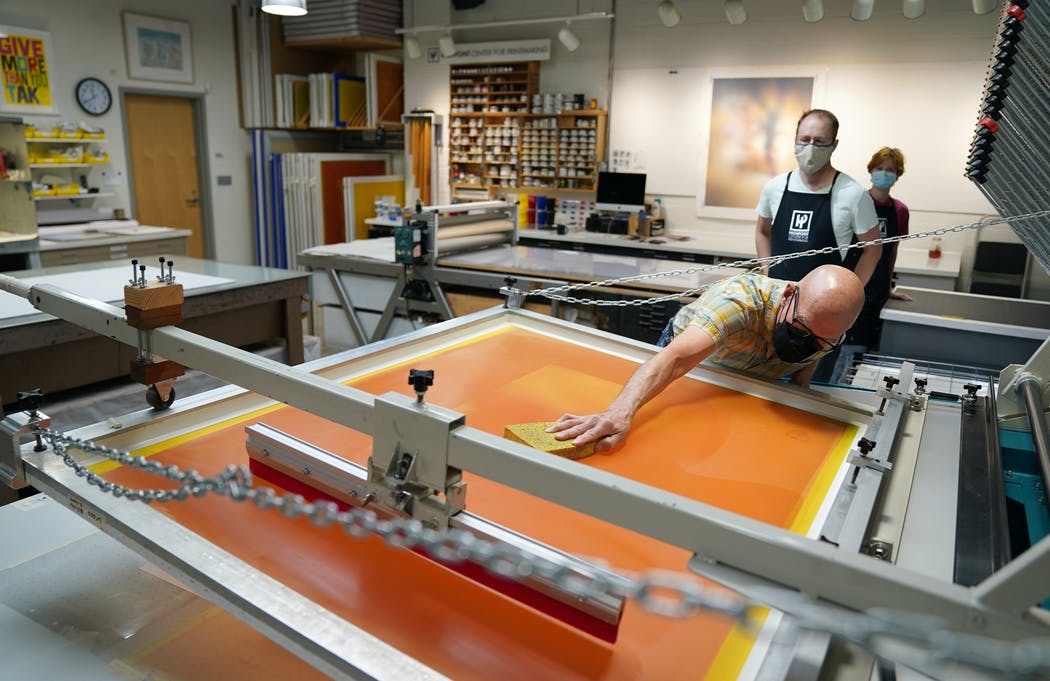 Cole Rogers at work in printmaking studio