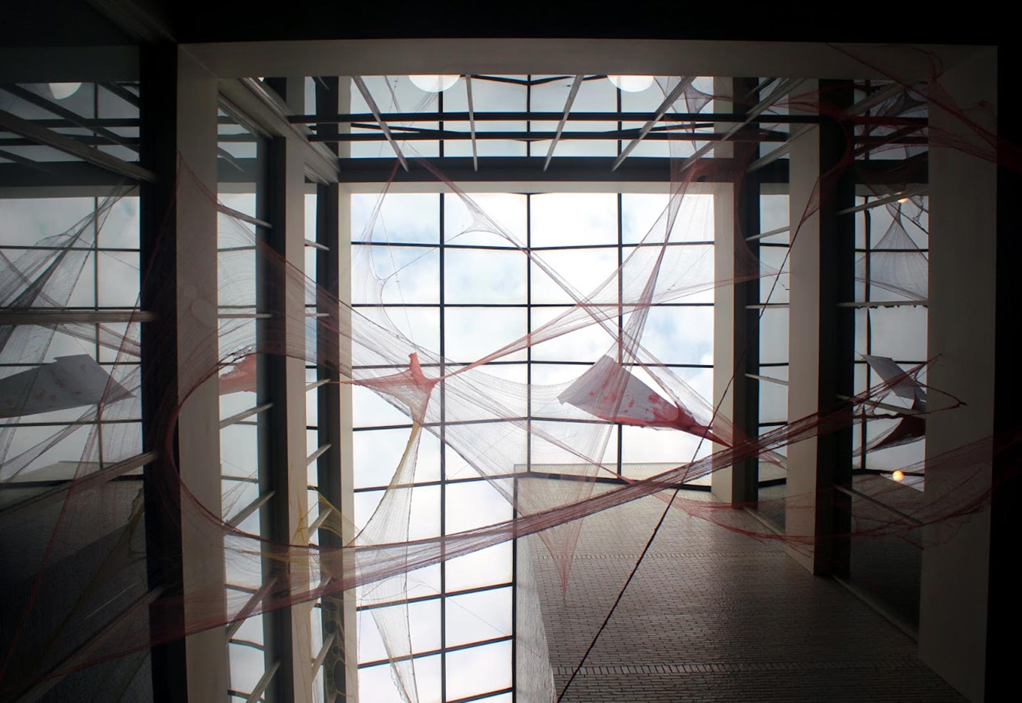 Textural installation involving windows by Janie Arguedas.