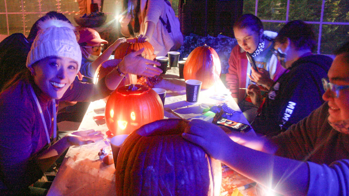 Students carving pumpkins.