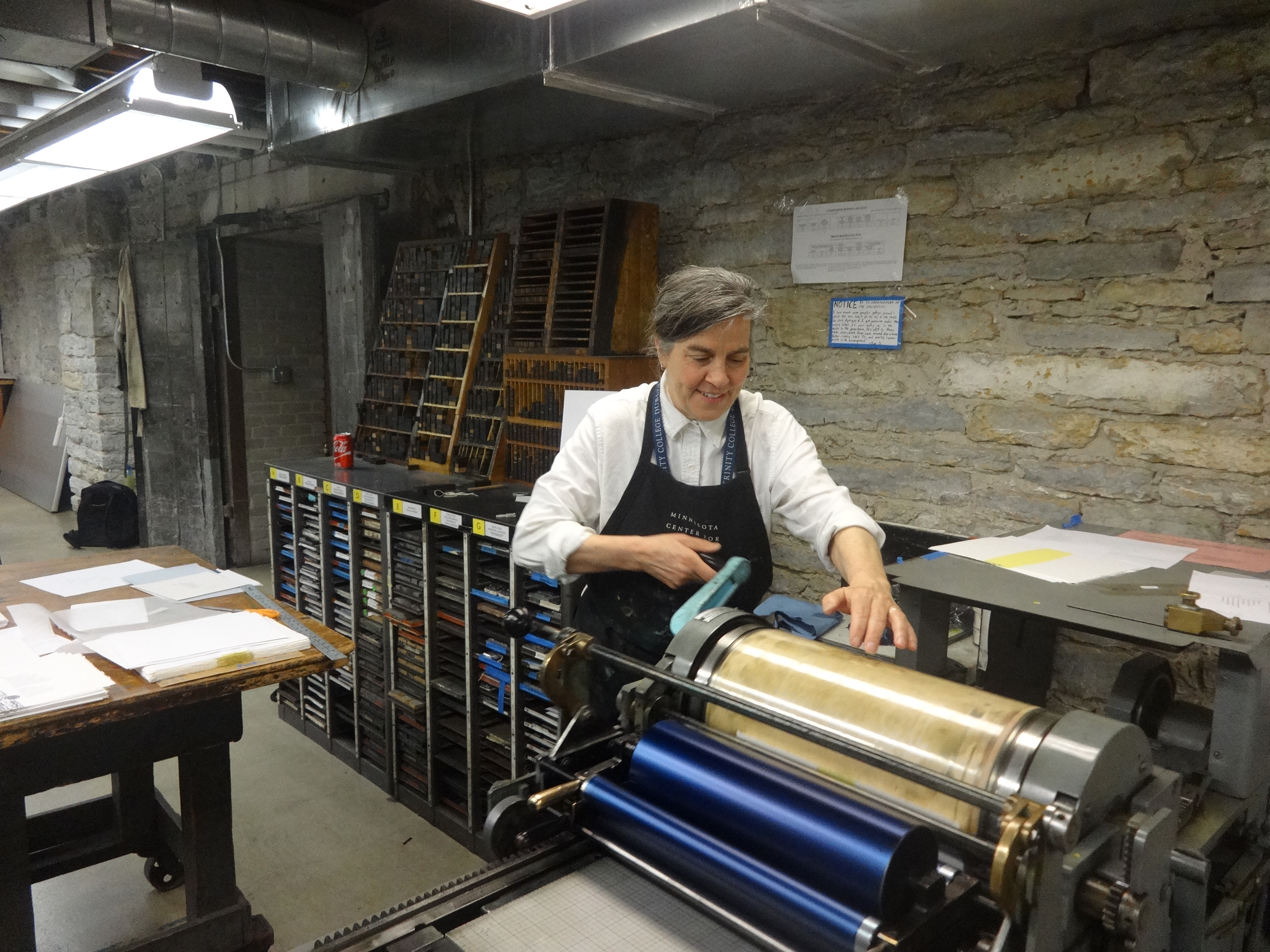 Julie Baugnet on the printing press