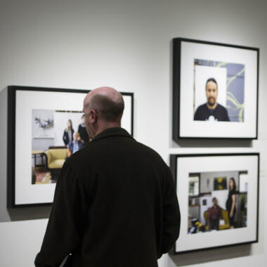 Visitor with Steve Ozone's work at the reception on October 7, 2016