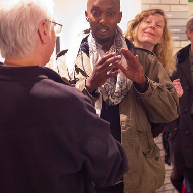 Mohamud Mumin talking with MCAD Faculty Rik Sferra at the reception on October 7, 2016