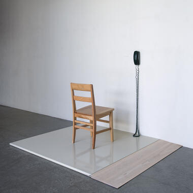 Emmett Ramstad, Untitled (Calling Station), 2016, bathroom stall partition, birch ramp, telephone, chair, phone, phone number, approx. 5' x 5' x 5'. Photo: Rik Sferra.