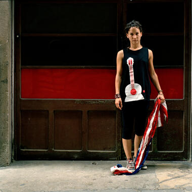 Lauri Lyons, Woman Standing on Flag (Spain), digital archival prints, 16 x 20 in.