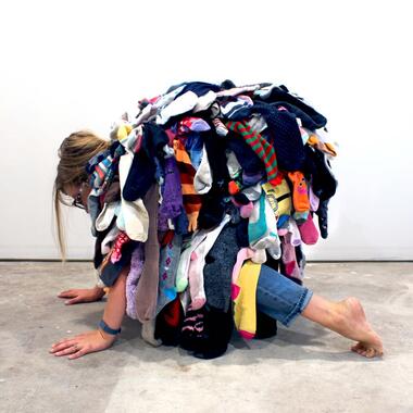 Laura Wennstrom; Motherload; Orphan socks collected from artist’s household and other caregivers in her neighborhood, cotton robe, thread; 2021; Photo credit: Cameron Browne
