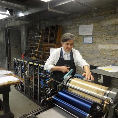 Julie Baugnet on the printing press