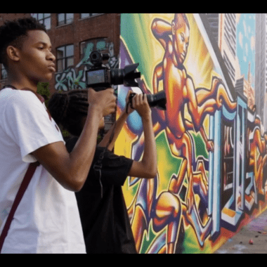 kids taking photos of a mural