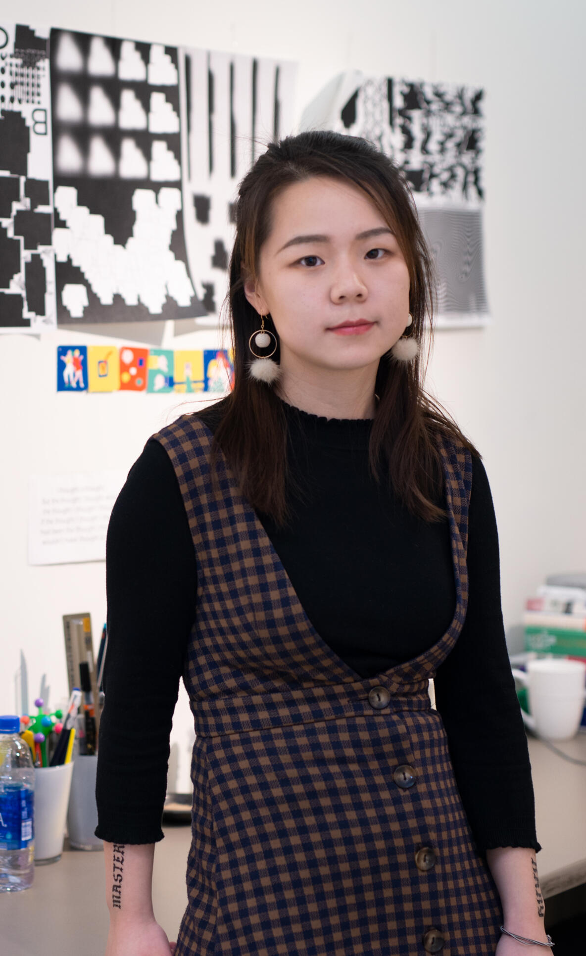 MFA student standing in front of their artwork