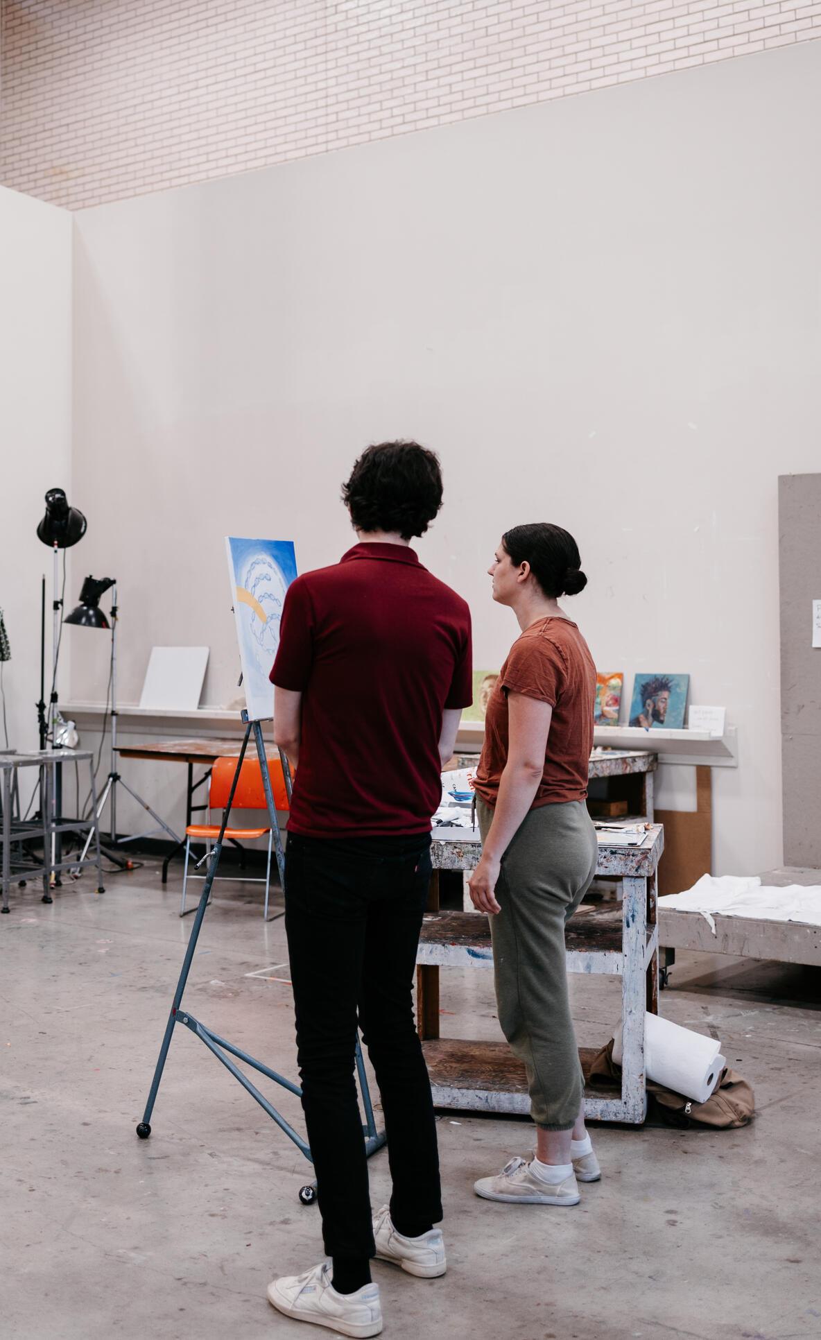 Teaching Artist Minor Hero Image: CE photography, two students standing in front of a canvas in the painting studio