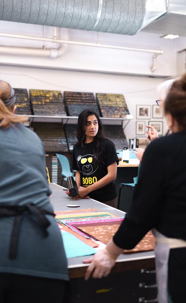 Print Paper Book Minor Hero Image: CE photography of a student in MCADs printshop