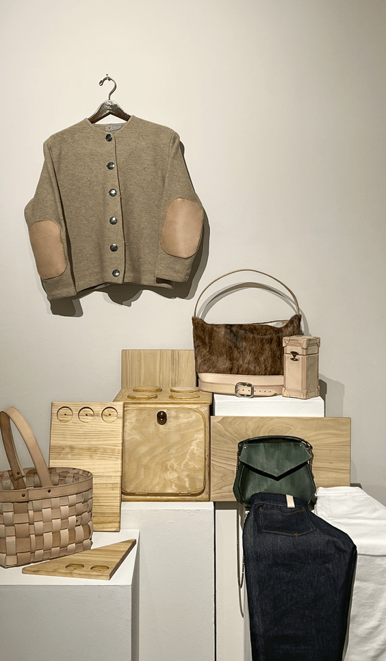 An assortment of apparel, baskets, purses, and wooden containers by Louie Lynch.. ; Louie Lynch