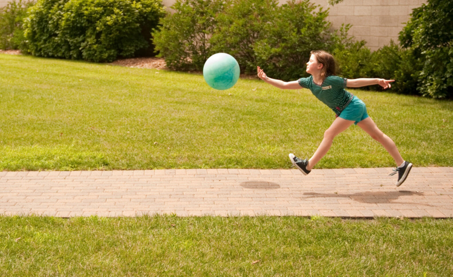 Kid playing with a ball