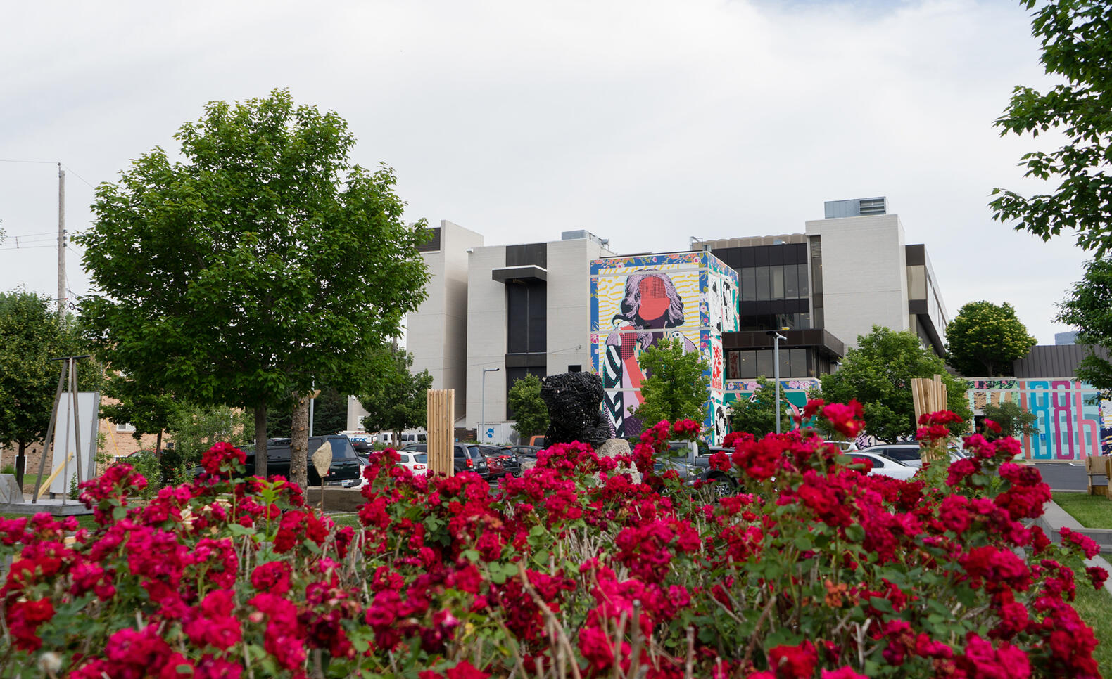 MCAD's FAILE mural, viewed behind a group of flowers.