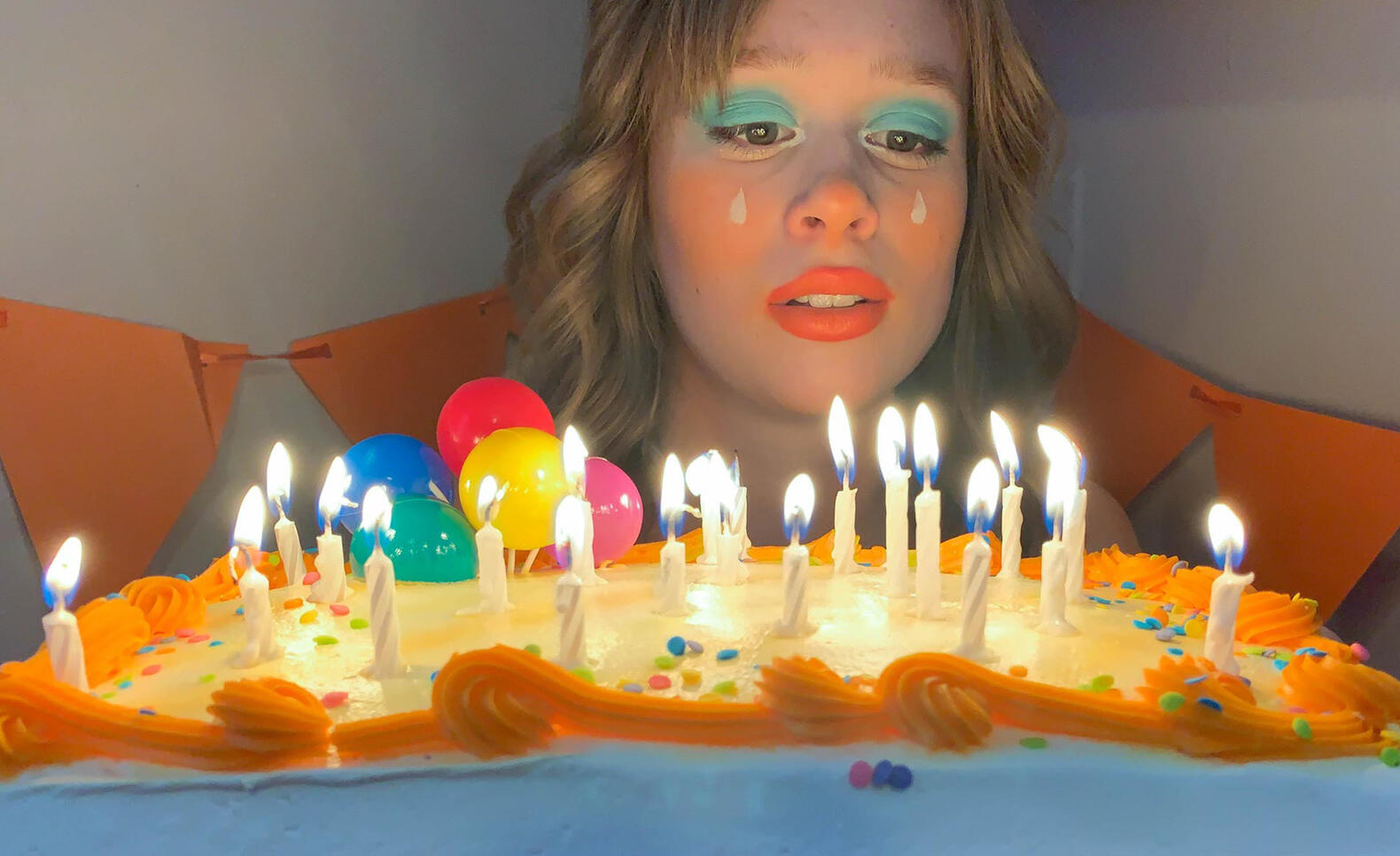 McKennan Marie in a halloween costume holding a birthday cake