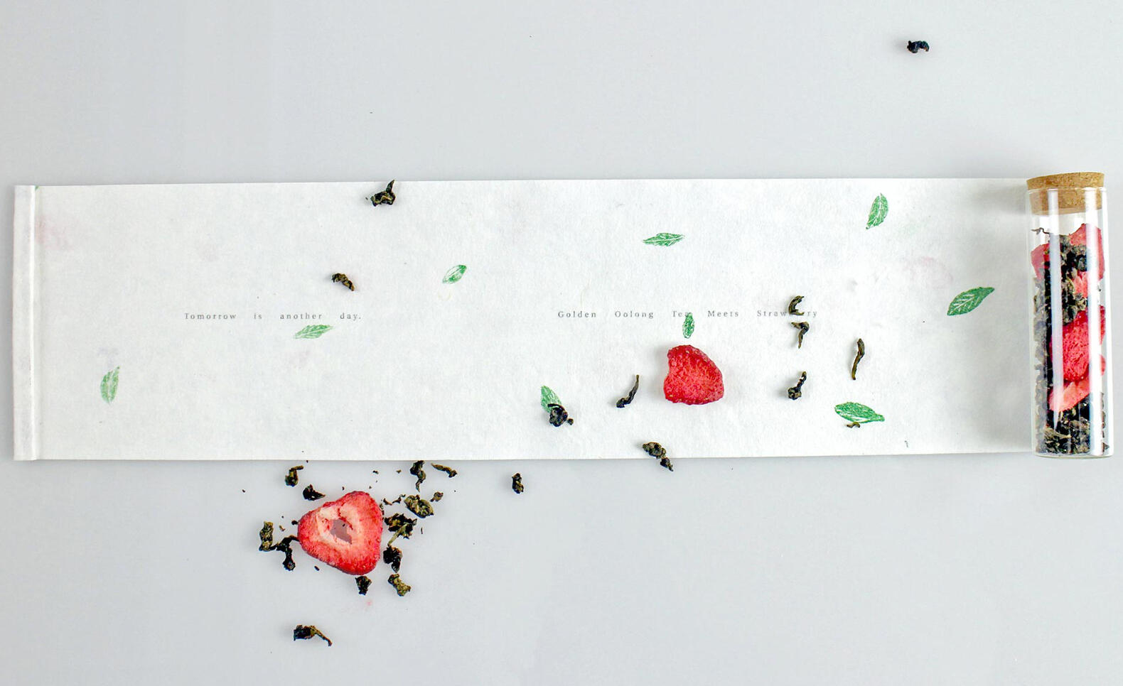 Photograph of a scroll, tea leaf, and strawberry ; Xingzi Liang