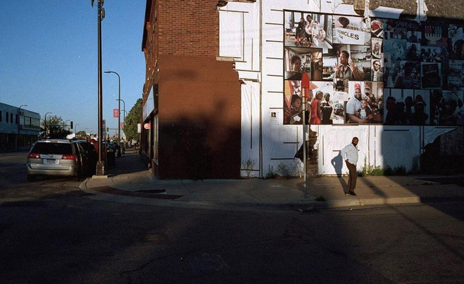 Photograph of someone walking on a sidewalk ; Dade Mann