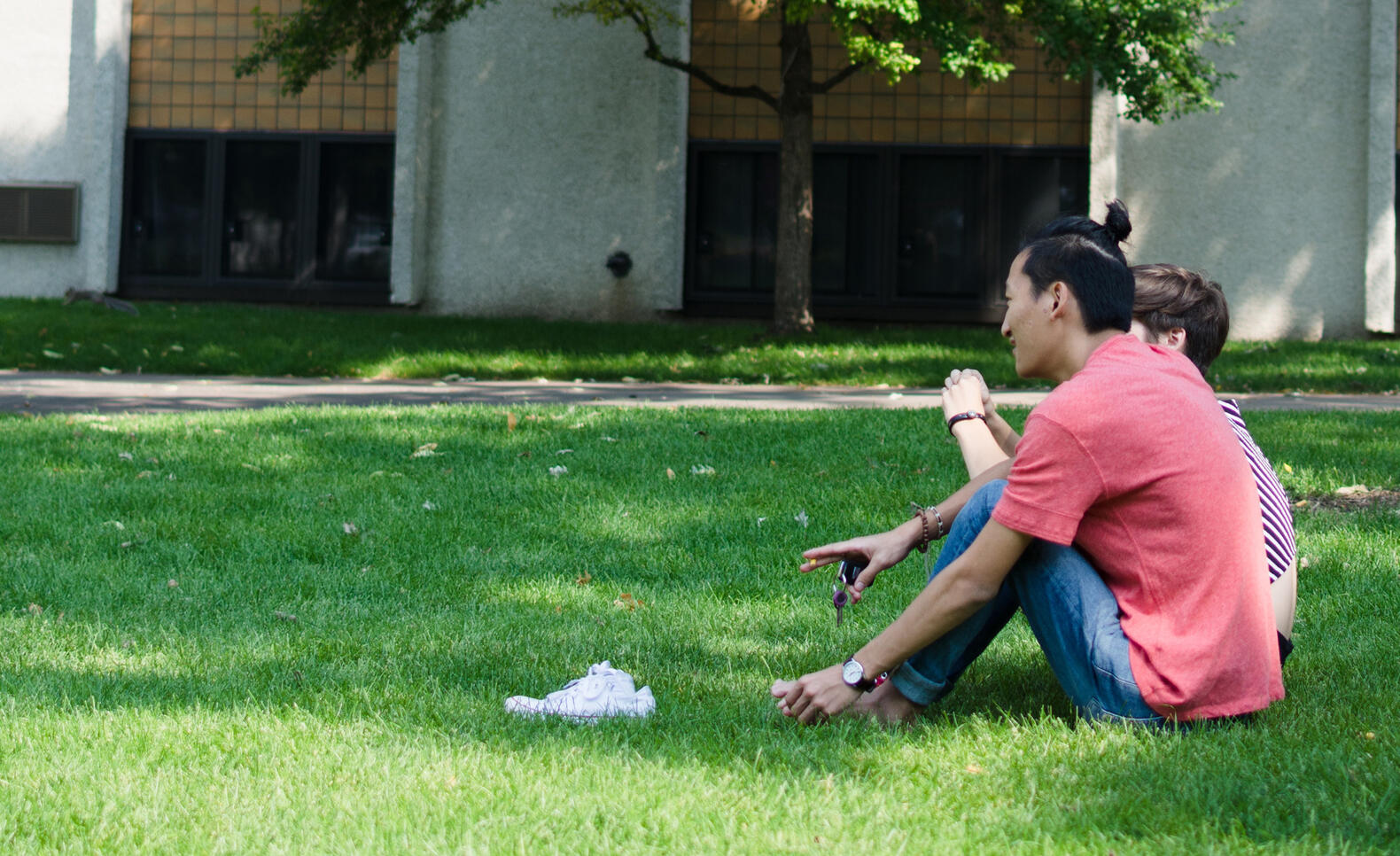 Two students sitting on MCAD's lawn