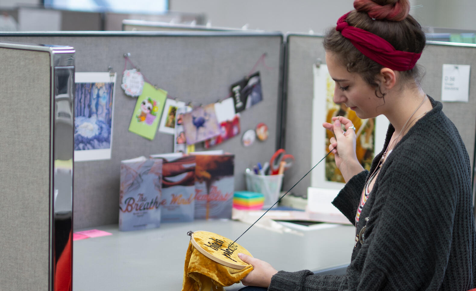 Student working on an embroidery in their studio