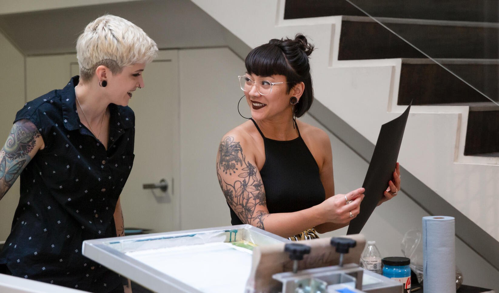 Two people working on a screenprint