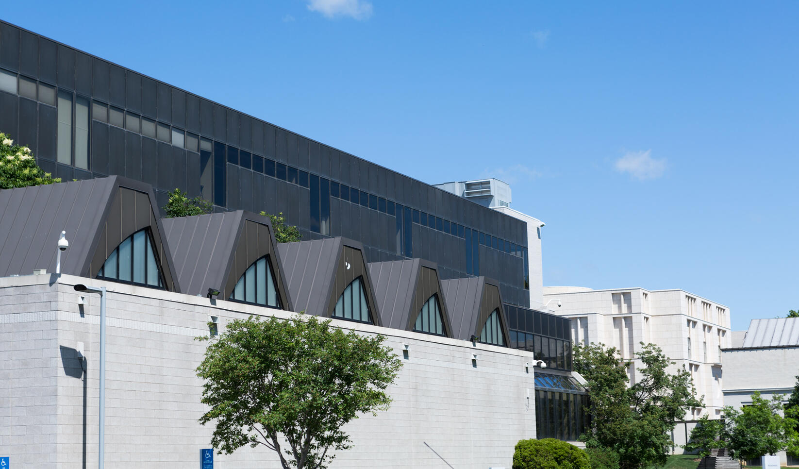 Minneapolis College of Art and Design campus in the summer with blue clear sky and showing the side of grey building