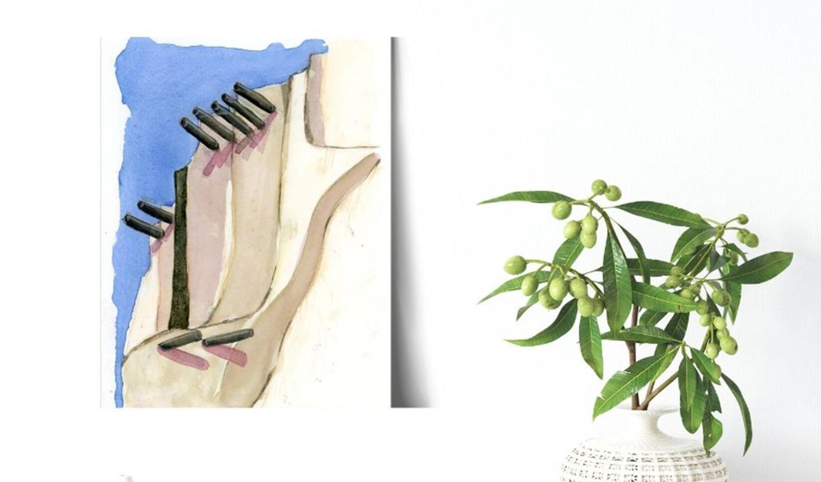 A blue and beige geometric painting next to a plant against a white wall