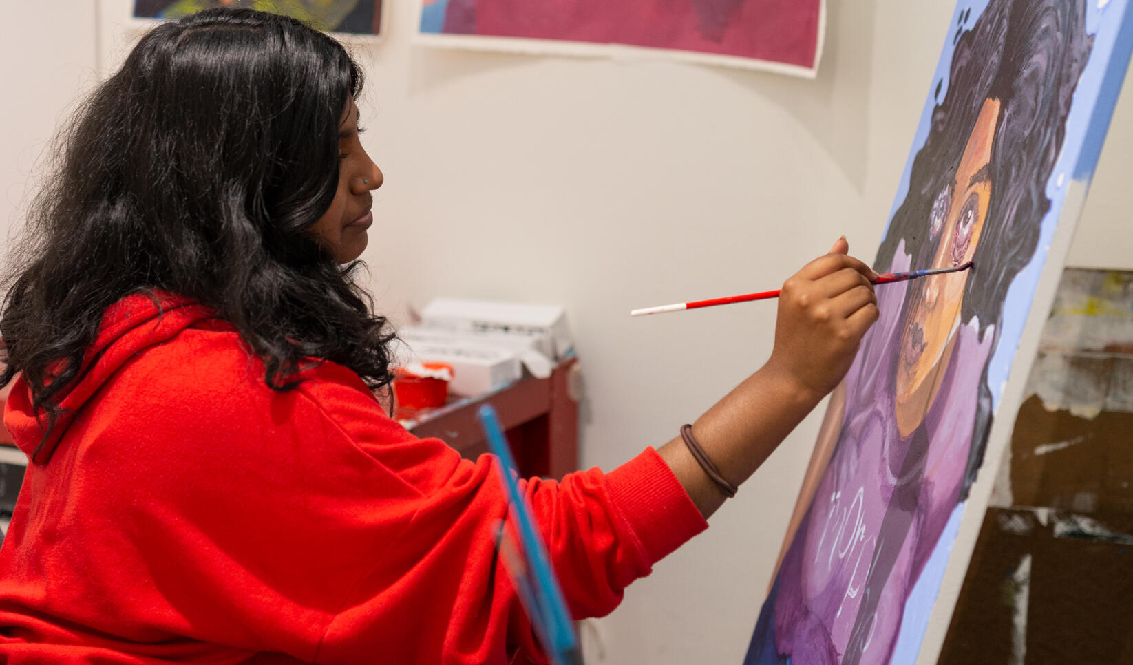 Student painting in their studio