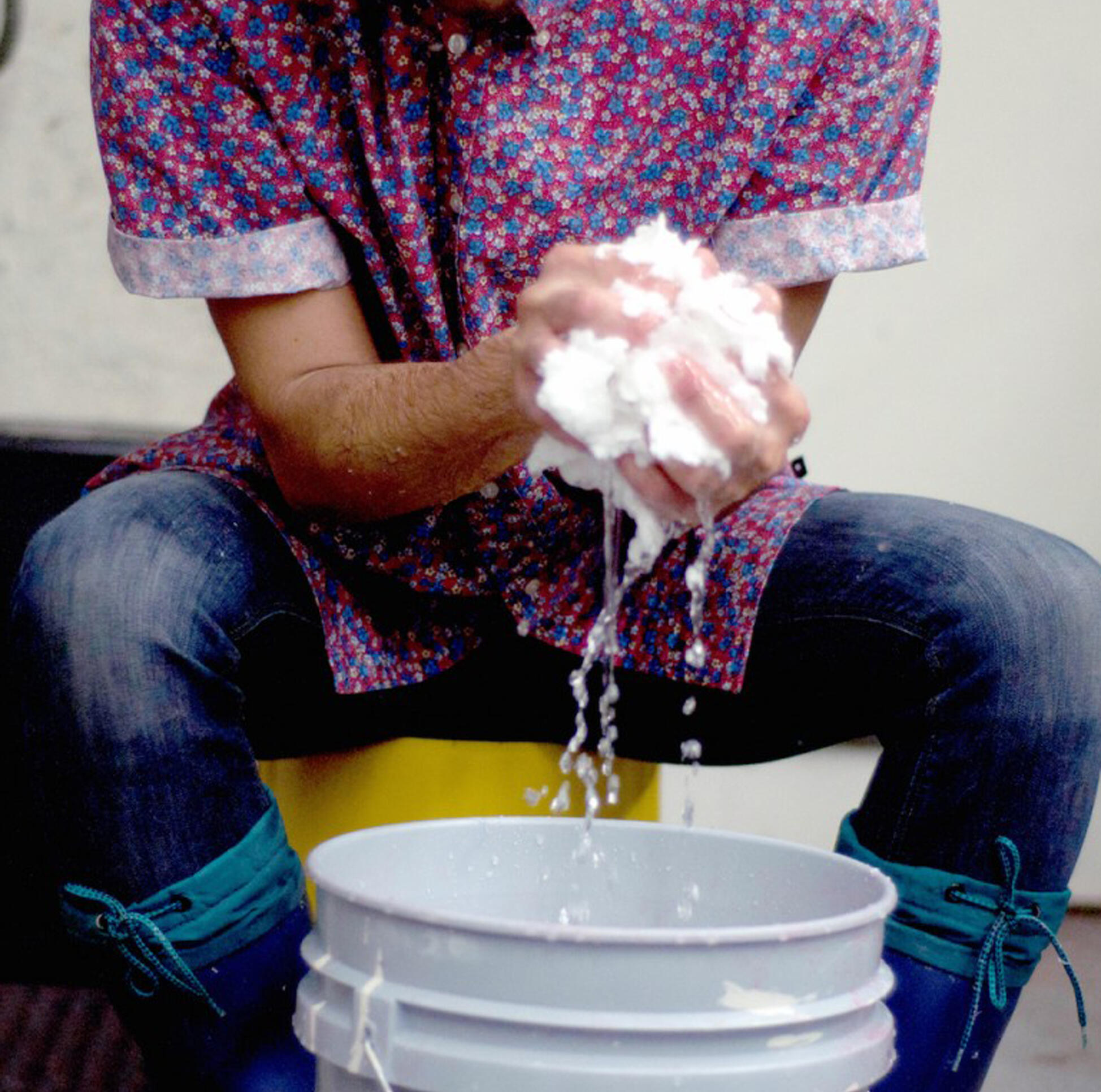 Close up of a student's hands working with paper pulp