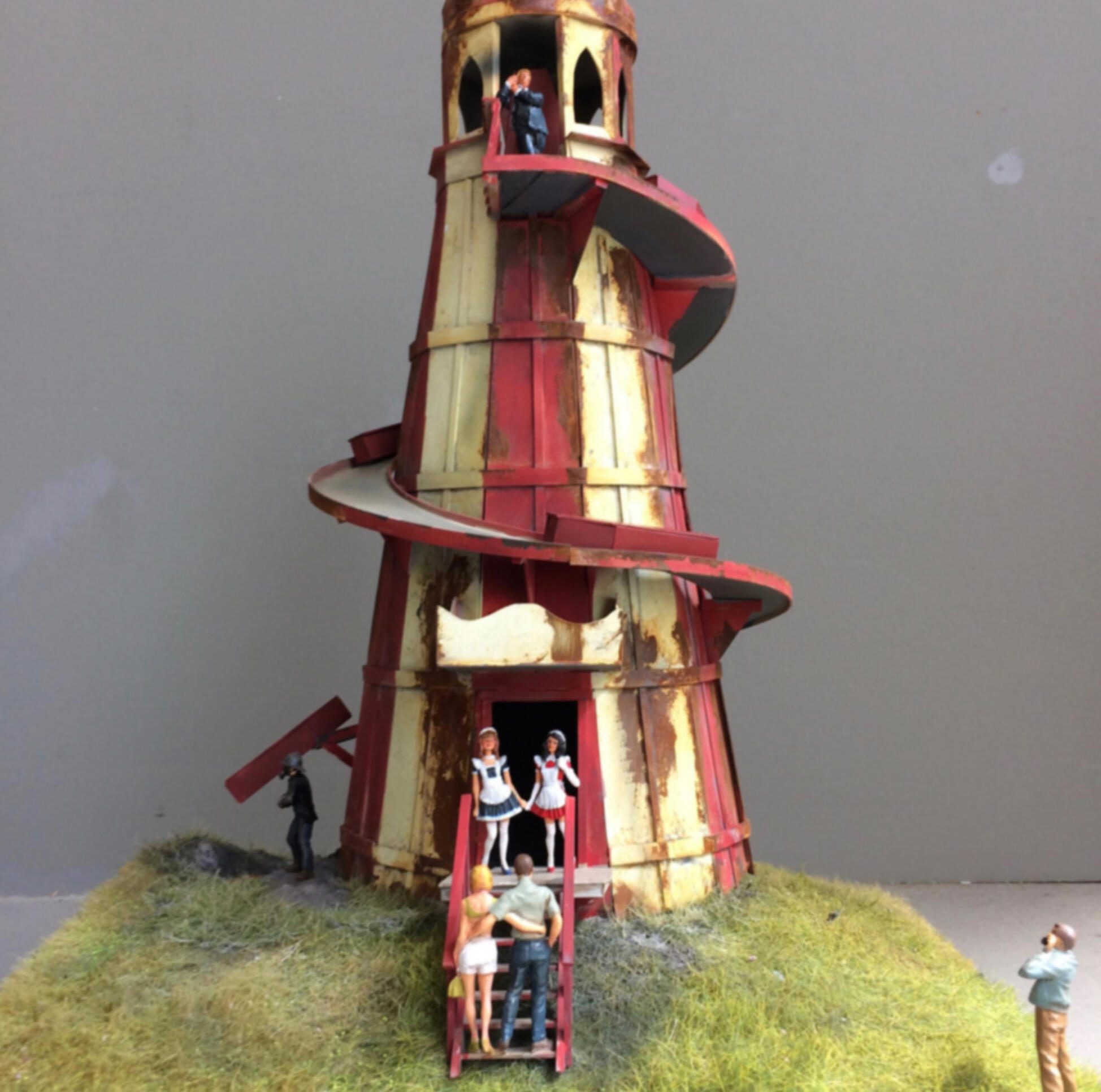 Miniature of a light tower with a winding road around it and several small miniatures of people in and around it. ; Howard Quednau
