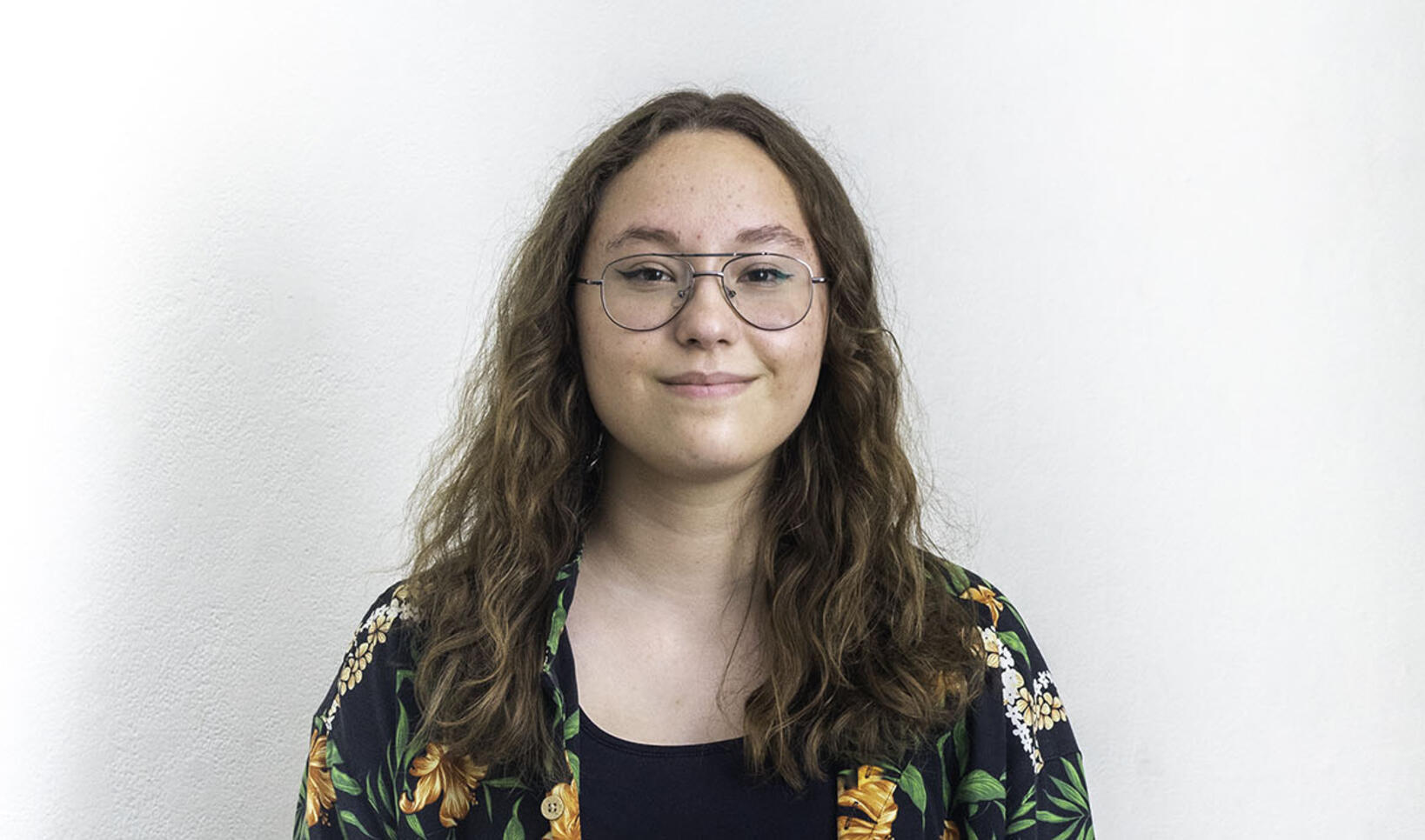 Profile picture of PCSS student wearing hair down and glasses.