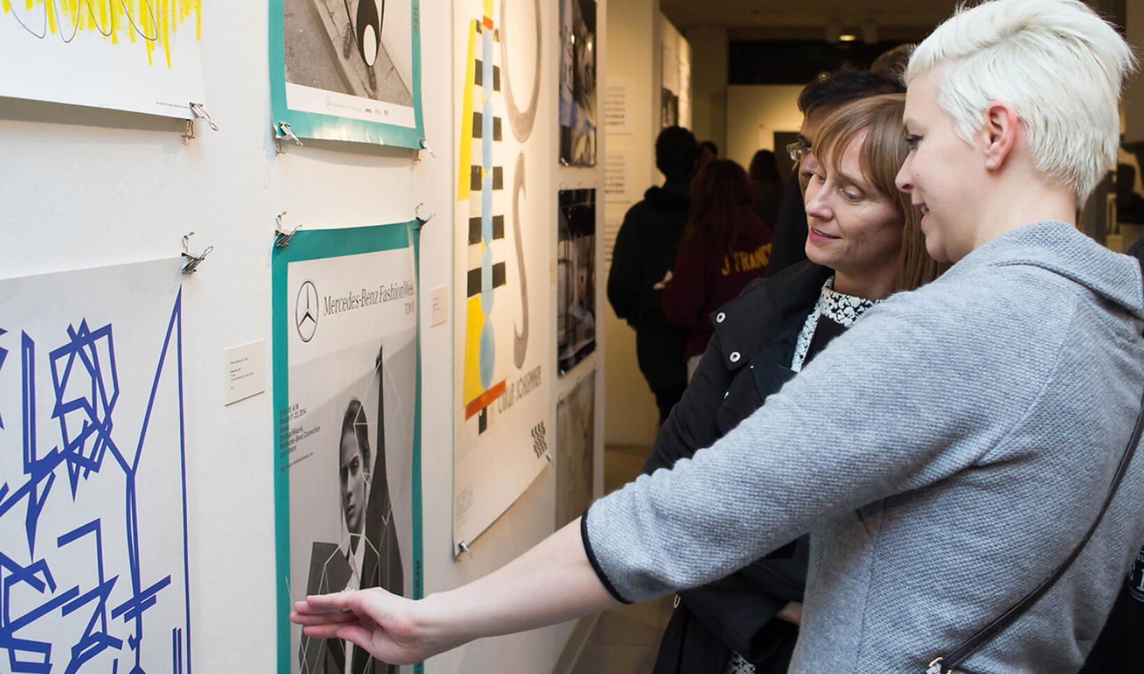 Two people looking at artwork