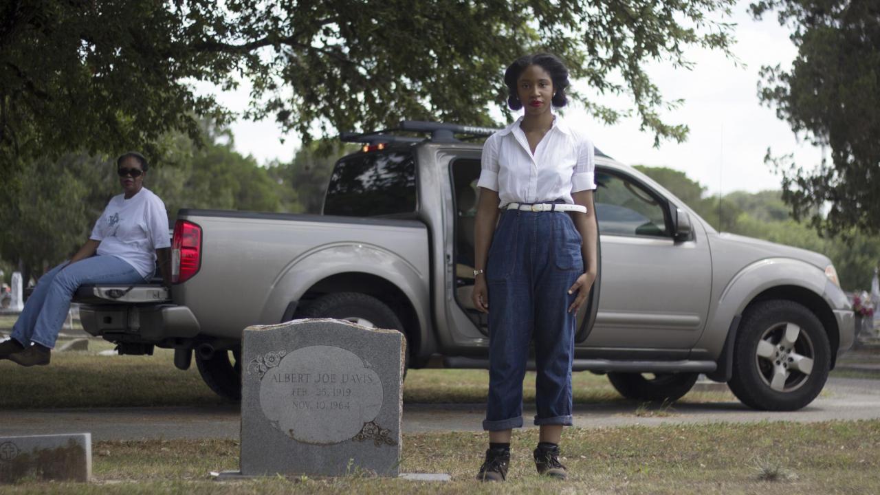 Candice Davis standing by a gravestone