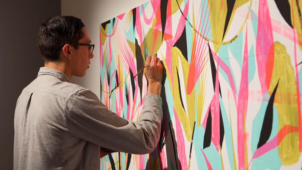 Eddie Perrote working on an bright, abstract drawing