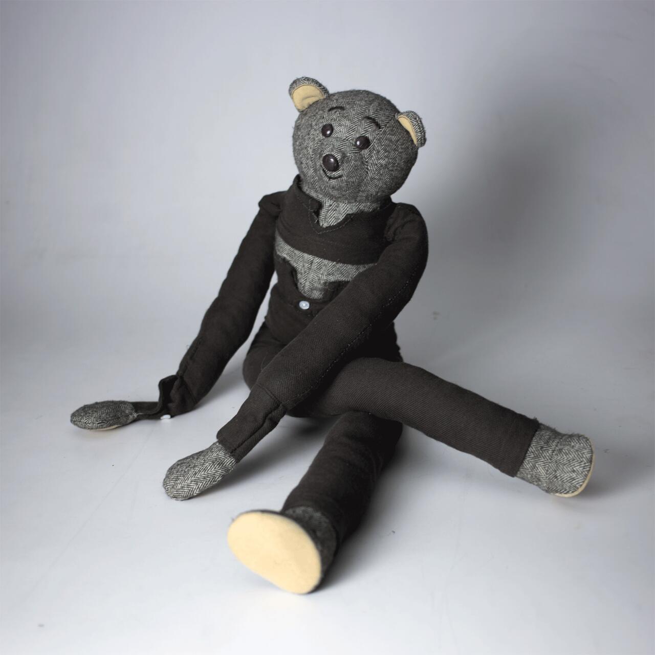 Photograph of a soft sculpture, composed of gray hues and other neutrals.