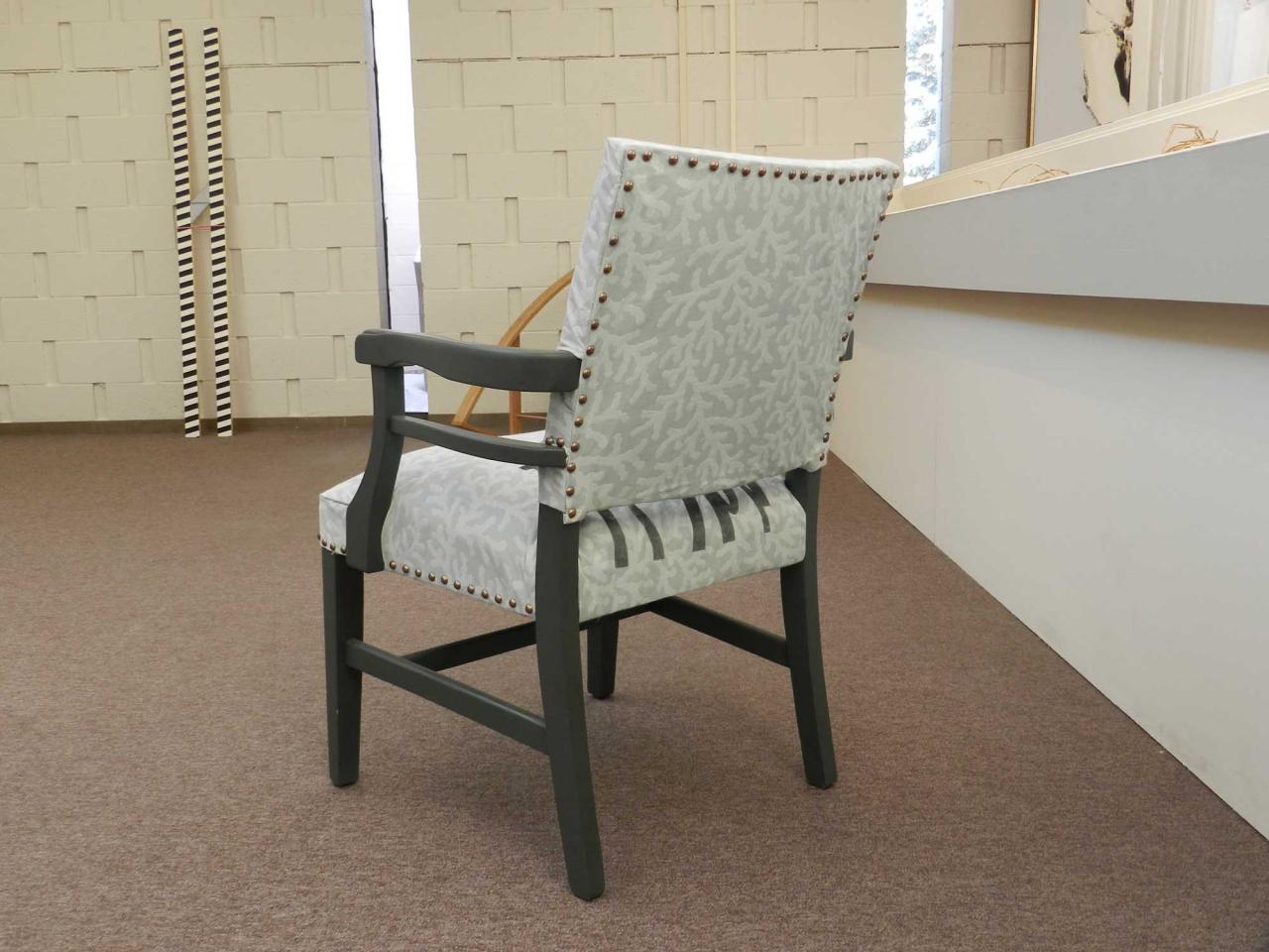 Screen printed fabric of grey and white on reupholstered chair. 