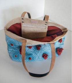 Tote bag composed of different materials, including printed fabric. Top view